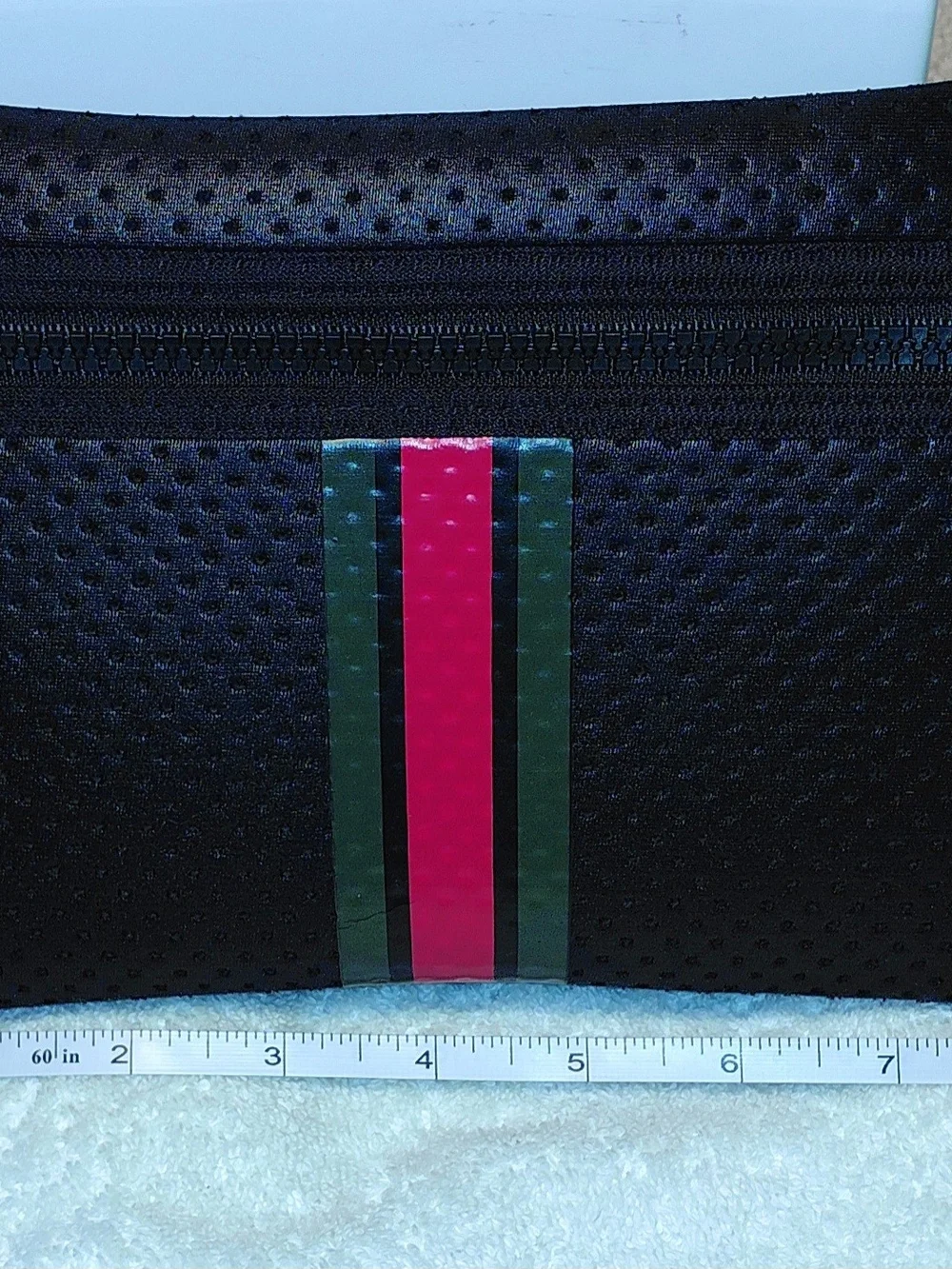 New perforated black leatherBlack Perforated Zip Pouch with Green and Red Stripe